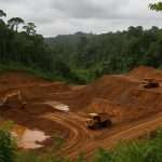 Mining site in an Indonesian forest with heavy machinery, illustrating the environmental issues addressed by the Indonesia forest mining regulation.