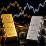 A high-resolution editorial photograph of stacked gold and silver bullion bars on a dark, reflective surface, symbolizing the current market volatility and investor sentiment in the precious metals sector.
