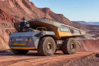 The restart of operations at Copper One in southeastern Utah on April 27, 2026, marks a watershed moment for the American extractive industry. Mariana Minerals has not just reopened a mine; it has launched the world’s first "autonomy-first" operation, where every drill, haul truck, and refinery circuit is unified under a single AI-driven operating platform known as MarianaOS. As the United States grapples with a structural copper deficit that threatens the pace of the energy transition, the success of the Mariana model is no longer a matter of corporate interest: it is a matter of national industrial strategy. With target cost reductions of 50% in mining and 30% in refining, the "Autonomous Pivot" represents a fundamental shift in how the industry approaches marginal assets and resource scarcity. The Anatomy of a Structural Deficit The context for Mariana’s restart is a tightening global market. In our recent analysis of the 2026 copper deficit, we highlighted how surging demand from AI data centers and EV infrastructure has outpaced new supply. Domestic production has been hampered by permitting delays and a dwindling talent pool, leaving the U.S. increasingly dependent on imports. Mariana Minerals’ pause in operations from late 2024 through April 2026 was a strategic gamble. Rather than continuing with traditional high-cost methods, the company spent 18 months integrating its autonomous software platform. The goal: to prove that a high-tech, low-cost domestic operation can compete with massive, low-grade overseas mines. A centralized remote operations center where engineers monitor real-time data from the MarianaOS platform. The MarianaOS Ecosystem: Why 50% Matters The headline figure of a 50% reduction in mining costs is ambitious, but it is grounded in the elimination of traditional operational inefficiencies. In a standard mine, the "hidden factory": time lost to shift changes, operator fatigue, and suboptimal equipment usage: can account for up to 20% of total costs. MarianaOS orchestrates the following three core pillars to drive these savings: Autonomous Drilling and Patterns: Utilizing high-precision GPS and real-time ore-body modeling, autonomous rigs adjust drill patterns on the fly to optimize fragmentation. This reduces the energy required for downstream crushing and grinding. Robotic Haulage: Without the need for driver breaks or cab-related safety constraints, Mariana's fleet of robotic trucks maintains a consistent 24/7 duty cycle. AI algorithms manage routing to minimize fuel consumption and tire wear. Refining Optimization: By integrating the refinery into the same AI stack, the system adjusts chemical inputs and heat based on the specific grade of ore coming out of the pit in real-time, reducing refining costs by 30%. This level of integration is a significant leap beyond the fragmented mining tech stacks currently used by most Tier-1 operators. Solving the "Silver Tsunami" with Silicon The pivot to autonomy is also a direct response to a looming labor crisis. Industry data suggests that over 200,000 workers in the U.S. mining sector are eligible for retirement this decade. Meanwhile, the pipeline for new talent is thin, with fewer than 400 mining engineers graduating annually. Mariana’s approach shifts the labor requirement from manual operation in harsh environments to high-value technical roles in remote operations centers. By reducing the physical headcount needed on-site, the company can operate Copper One with a leaner, more specialized team that manages the AI orchestration rather than the hardware itself. High-precision autonomous drilling rigs at Copper One optimize blast patterns for maximum efficiency. Scaling to 50,000 Tons: The 2030 Roadmap Mariana Minerals isn't stopping at the current production levels. The company’s roadmap targets a scale-up to 50,000 metric tons of high-purity copper cathode per year by 2030. To manage this expansion, they are utilizing "CapitalProjectOS," a sister platform to their operational AI. This system integrates engineering, procurement, and construction (EPC) data into a single predictive model. By identifying potential supply chain bottlenecks or geological risks months in advance, Mariana aims to avoid the cost overruns that often plague major mining expansions. As seen in the strong production growth of peers like Capstone Copper, operational efficiency is the key to capturing value during periods of high commodity prices. Mariana’s ability to scale quickly through software-driven project management could serve as a blueprint for other junior and mid-tier miners. Geopolitical Implications and the Path Forward The "Autonomous Pivot" is more than an engineering feat; it is a proof of concept for U.S. mineral independence. If Mariana can sustain its 30-50% cost reduction targets, it lowers the "incentive price" for domestic copper production. This means previously uneconomic deposits in the U.S. could be brought online, shortening supply chains and reducing the carbon footprint associated with long-distance mineral transport. However, challenges remain. The reliance on 24/7 connectivity and high-speed data transmission makes autonomous mines vulnerable to cybersecurity threats. Furthermore, the massive upfront capital investment required for MarianaOS and a robotic fleet is a barrier that many debt-laden producers may find difficult to hurdle. As Copper One ramps up through the summer of 2026, the industry will be watching the data closely. If Mariana Minerals succeeds, the future of mining won't just be underground: it will be in the cloud.